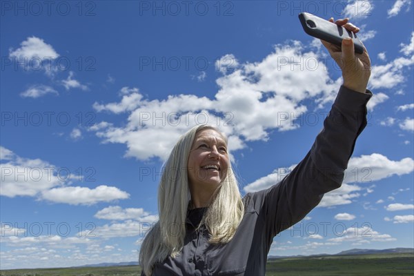 Older Caucasian woman taking selfie