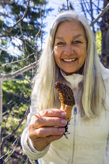 Caucasian woman holding morel