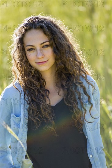 Caucasian woman standing in field of tall grass