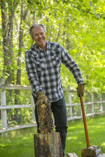 Caucasian man chopping wood