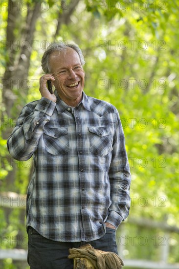 Caucasian man talking on cell phone outdoors