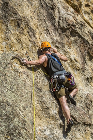 Caucasian man climbing rock