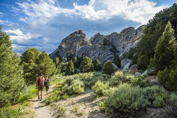 Caucasian couple hiking toward mountain