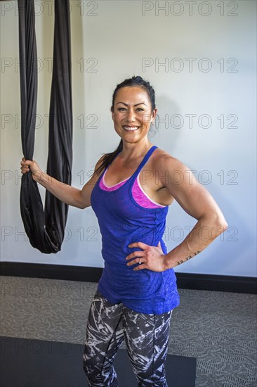 Mixed Race woman posing with hanging silks