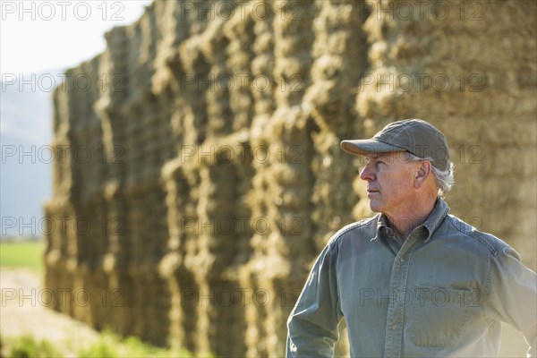 Caucasian farmer near stacks of hay