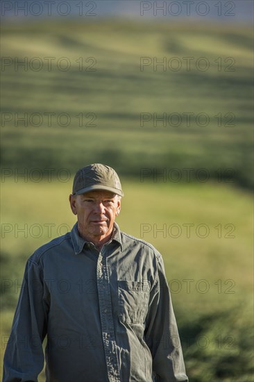Caucasian farmer standing in field
