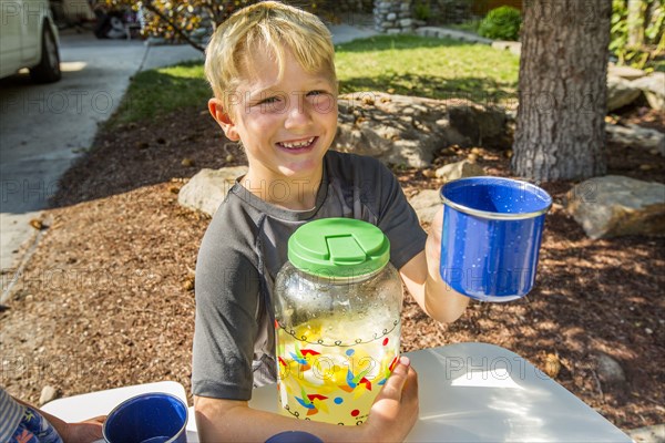 Smiling Caucasian boy posing with lemonade