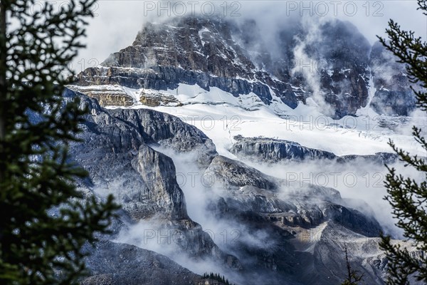 Fog on snowy mountain range