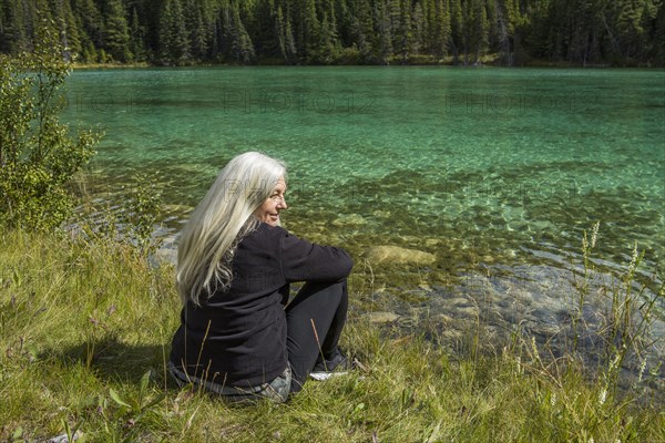 Caucasian woman sitting near river