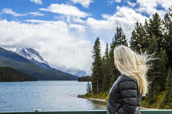 Caucasian woman standing near mountain lake