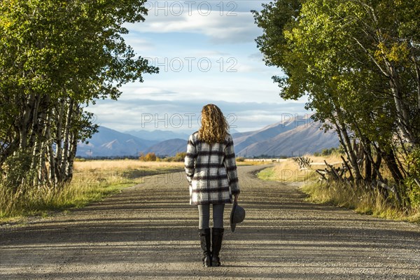 Caucasian woman standing on dirt road