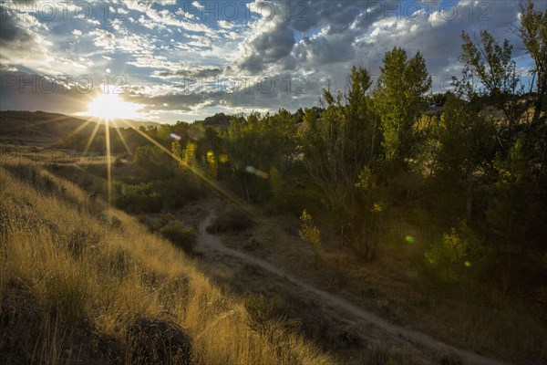 Sunset over distant mountain path