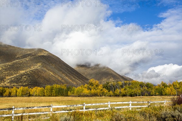 Fence and mountain under clouds