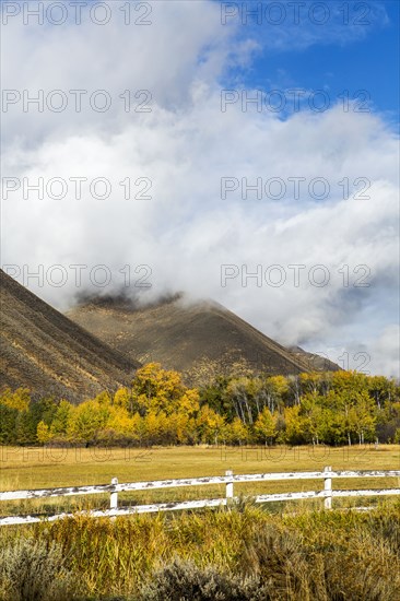 Fence and mountain under clouds