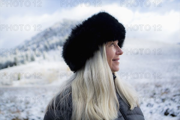 Caucasian woman wearing fur hat in winter