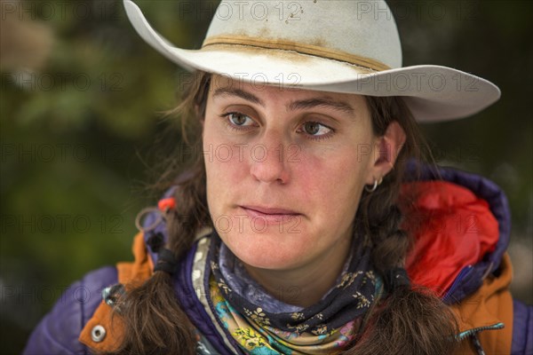 Portrait of serious Caucasian woman wearing cowboy hat