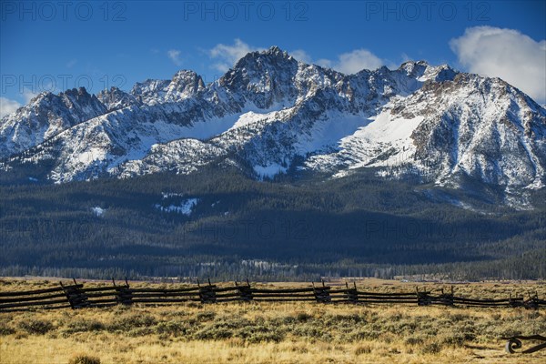 Wooden fence near snowy mountain