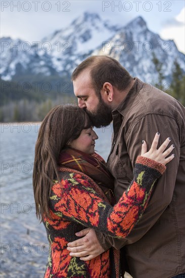 Caucasian couple kissing near river