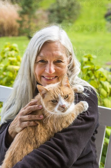 Portrait of smiling Caucasian woman holding cat