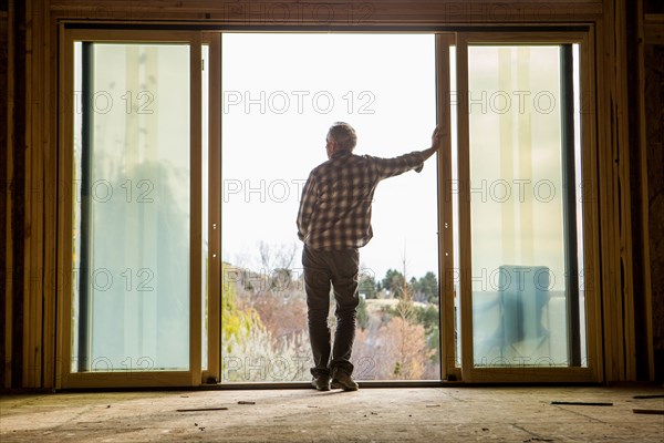 Caucasian man leaning in doorway