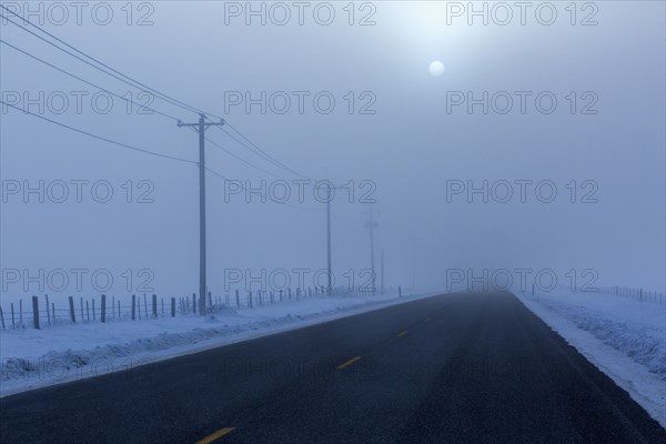 Full moon over road in winter