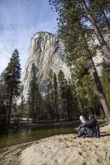 Caucasian couple sitting near river