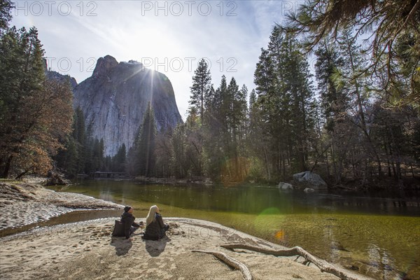 Caucasian couple sitting near river