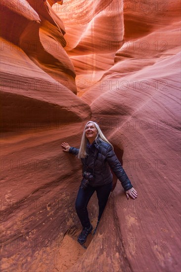 Caucasian woman walking in rock formation