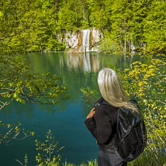 Older Caucasian woman admiring waterfall