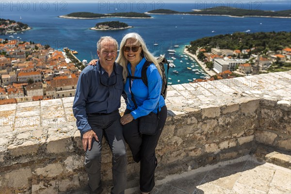 Caucasian couple posing near scenic view of ocean