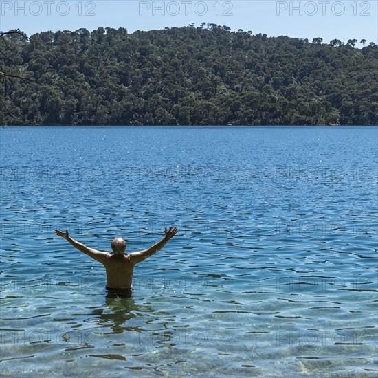 Caucasian man wading in water