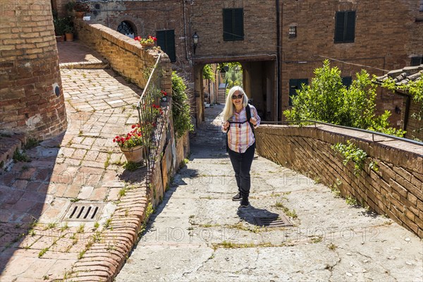 Caucasian woman hiking urban hill