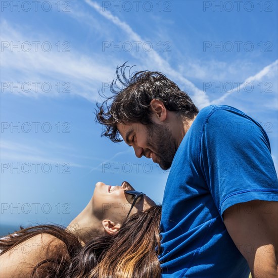 Caucasian woman laying in lap of man