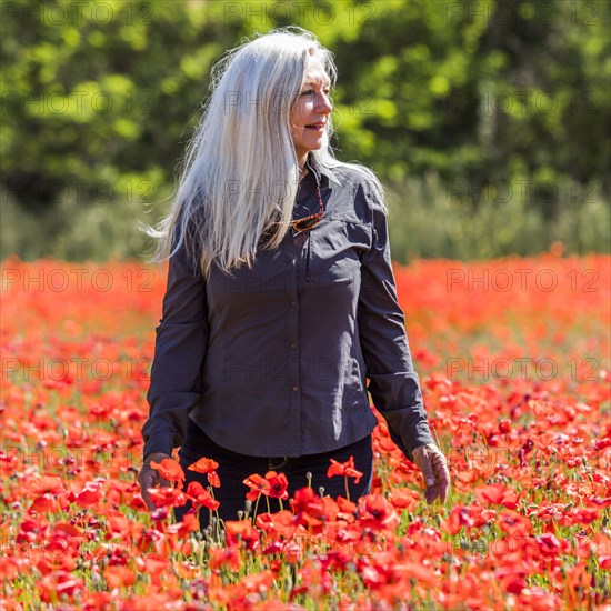 Caucasian woman looking away in field of flowers