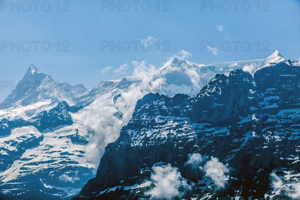 Clouds on snowy mountains