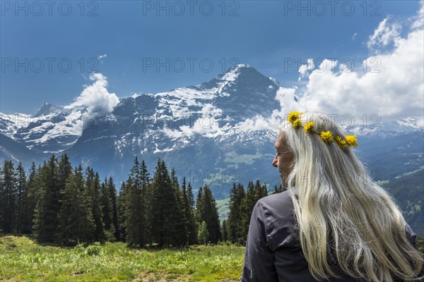 Caucasian woman wearing crown of flowers near mountains