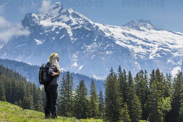 Caucasian woman wearing crown of flowers admiring scenic view of mountain