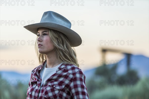 Caucasian teenage girl wearing cowboy hat