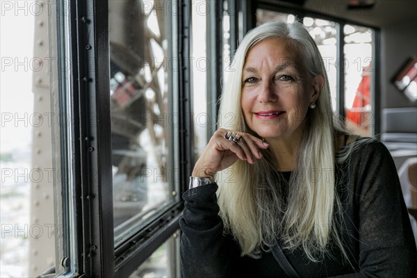 Portrait of smiling Caucasian woman near window