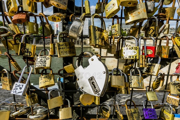 Padlocks on fence at river