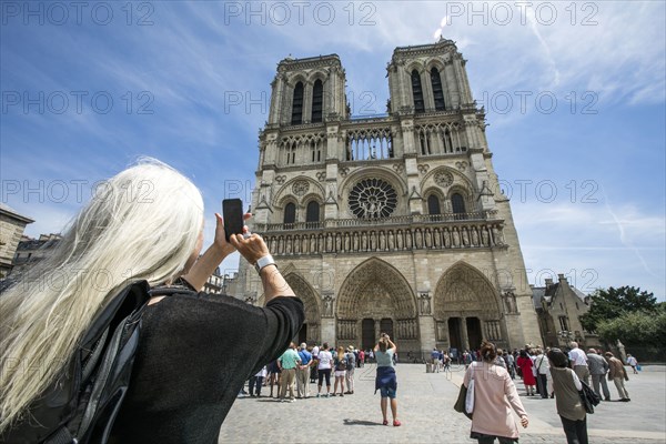 Caucasian woman photographing building