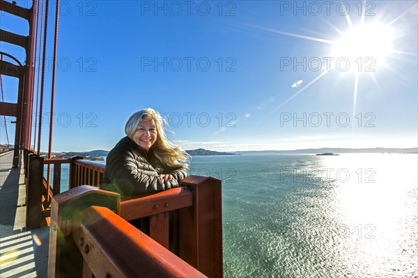 Portrait of smiling Caucasian woman on bridge