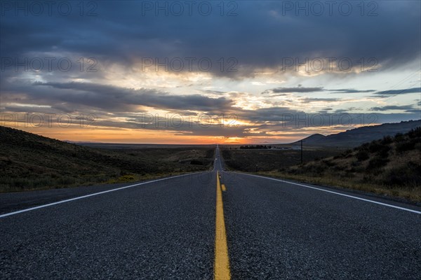 Empty remote road at sunset