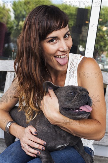 Caucasian woman imitating dog with tongue out