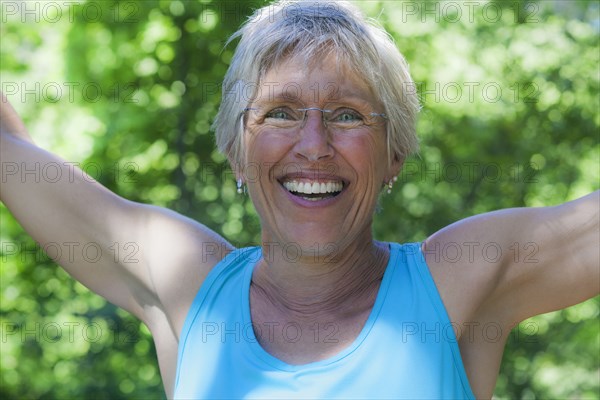 Smiling Caucasian woman celebrating outdoors