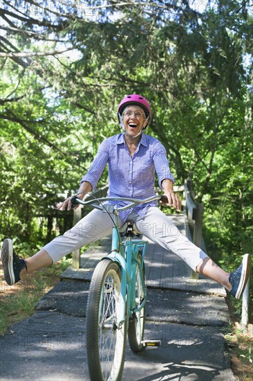 Caucasian woman sitting on bicycle with legs apart