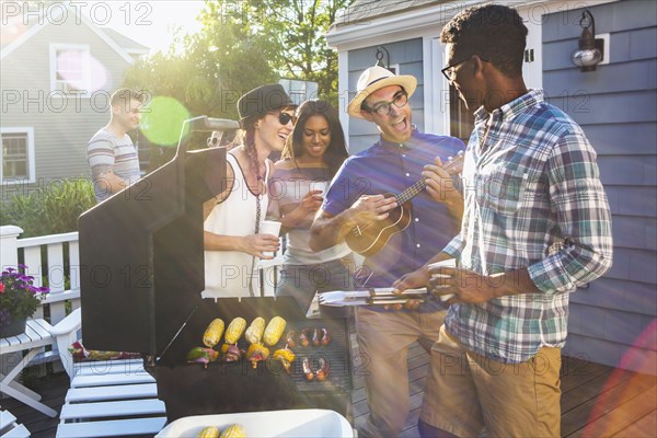 Friends enjoying barbecue on patio