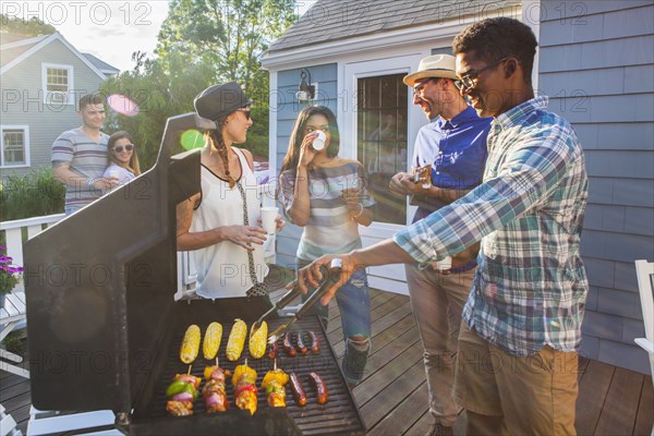 Friends enjoying barbecue on patio