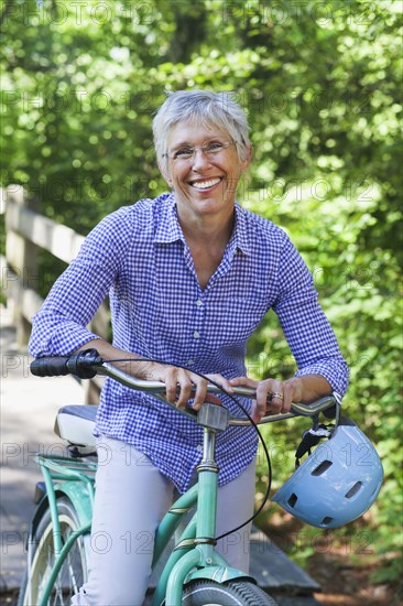 Portrait of Caucasian woman posing with bicycle