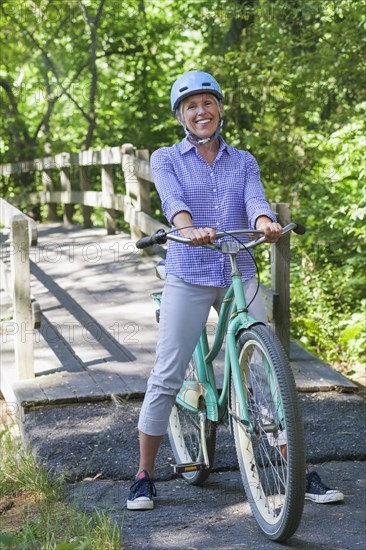 Portrait of Caucasian woman posing with bicycle